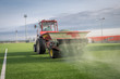 © Dziurek - Pouring infill granules in to a football pitch with artificial grass.