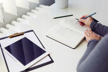 Wall Mural - woman sketching graphic design in his diary for new website