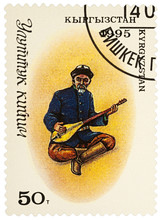 Man In Traditional Kyrgyz Clothes With Comus On Postage Stamp