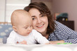 © Africa Studio - Young mother and her baby lying on bed at home