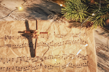 Wall Mural - Christmas composition with wooden cross and music sheet on table