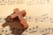 Wooden cross on music sheet