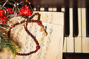 Wall Mural - Christmas composition with rosary beads and music sheet on piano