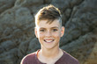 © Cavan Images - Portrait of smiling boy standing outdoors