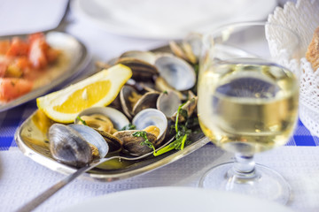 Wall Mural - Clams served on silverware with white wine