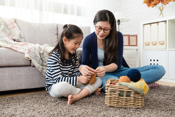 Wall Mural - mom teaches her daughter knitting