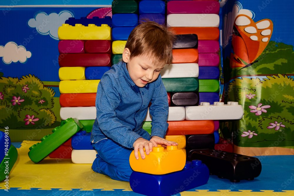 boy builds a pyramid of large parts of the designer Stock Photo | Adobe ...