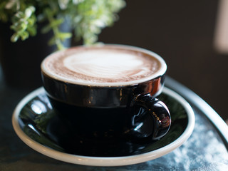 A cup of hot chocolate with milk froth.