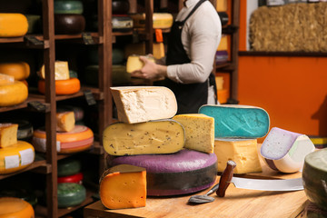 Canvas Print - Different cheeses on table in shop