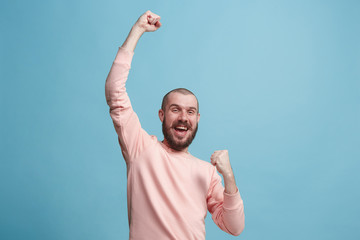 winning success man happy ecstatic celebrating being a winner. dynamic energetic image of male model