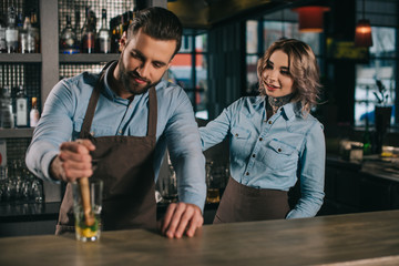 Wall Mural - bartenders preparing alcohol drink at bar