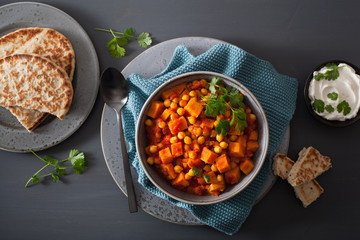 Wall Mural - sweet potato and chickpea curry with naan bread