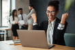 © Drobot Dean - Happy young african business woman make winner gesture.