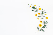 Flowers Composition. Pattern Made Of Yellow Flowers And Eucalyptus Leaves On White Background. Flat Lay, Top View, Copy Space
