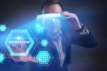 Business, Technology, Internet and network concept. Young businessman working in virtual reality glasses sees the inscription: Workflow