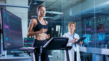 Wall Mural - man wearing brainwave scanning headset sits in a chair while scientist with tablet computer supervis