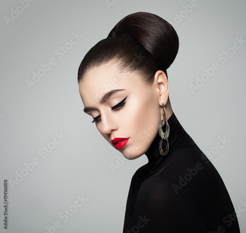Elegant Young Woman With Hair Bun Hairstyle And Eyeliner