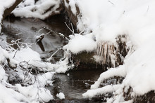 Small Partially Frozen Stream And Snow