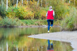 © dima - A girl runs in the forest on the shore of the pond