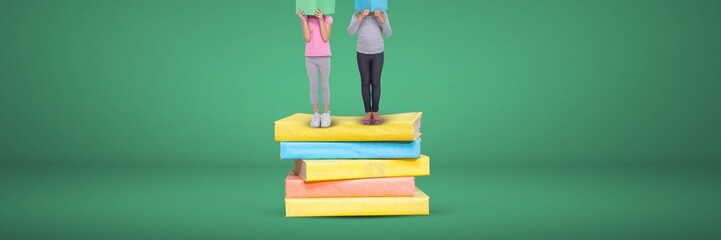 Poster - Two girls reading and standing on a pile of books with green