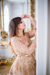 © popovatetiana - Portrait of beautiful lady in gold dress, side view
