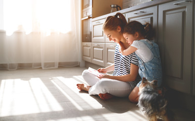 happy mother's day! child daughter congratulates her mother and  read postcard