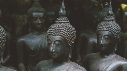 Wall Mural - Big Buddha statues in the local Thai market. Antique Buddha statues close-up 