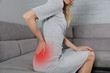 Woman suffering from low back pain. Incorrect sitting posture problems, Muscle spasm, rheumatism. Pain relief, ,chiropractic concept.