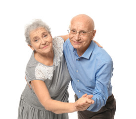 Wall Mural - Cute elderly couple dancing against white background