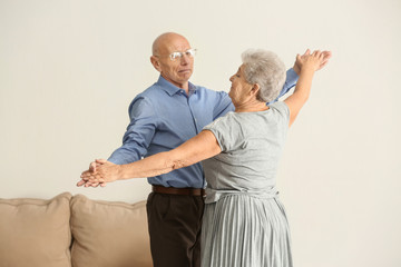 Wall Mural - Cute elderly couple dancing at home