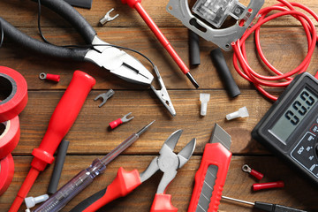 Different electrical tools on wooden background