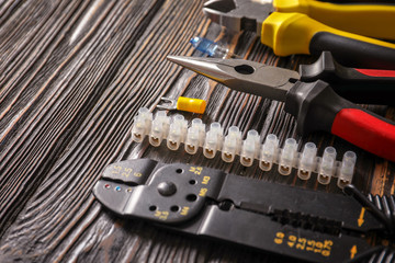 Different electrical tools on wooden background