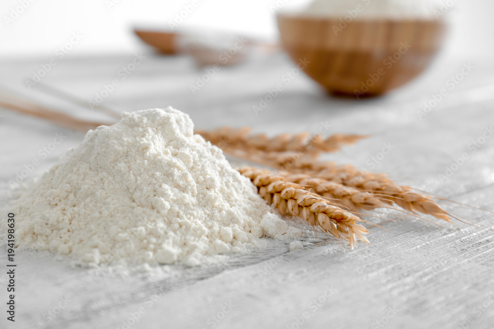 Heap of flour on wooden table