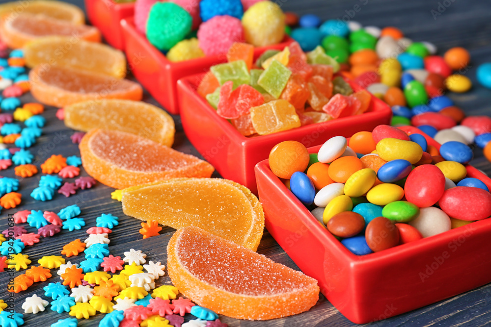 Colorful candies on wooden background