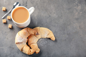 Sticker - Tasty crescent rolls and cup of coffee on grey background