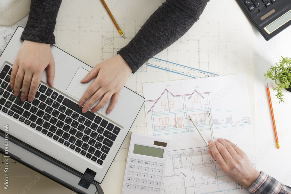 Stock-Foto „Architects working on blueprint, real estate project ...