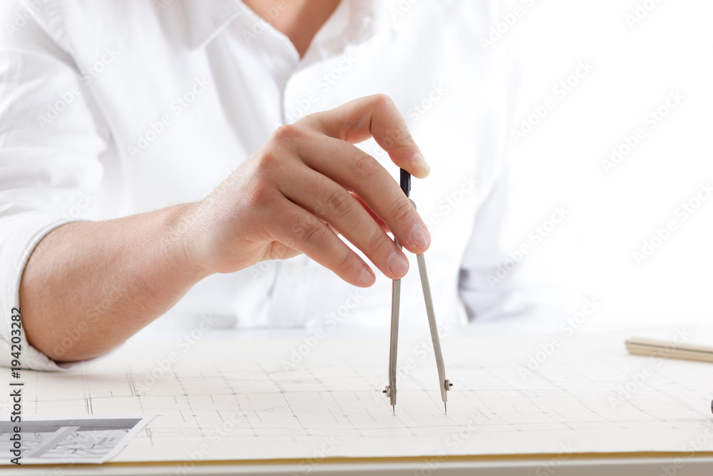 Architects working on blueprint, real estate project. Architect ...