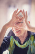 Cute senior old woman making a heart shape with her hands and fingers
