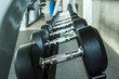 © taaee - Dumbbells in the gym weight Training Equipment.