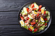 Delicious gourmet nicoise salad with vegetables, eggs, tuna and anchovies close up on a plate. Horizontal top view