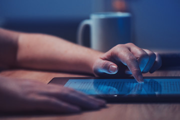 Woman reading online news on digital tablet