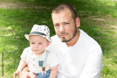 Fotografie, Obraz Cheerful father playing with his son on meadow