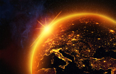 Wall Mural - vision of the earth in outer space,the light of the rising sun floods europe with a golden glow