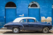 Blauer amerikanischer Oldtimer mit weissem Dach parkt vor einem historischen Gebäude in Havanna City Kuba - Serie Cuba Reportage
