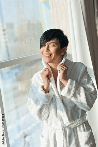 Asian Girl Brunette With A Short Haircut In A White Coat Is