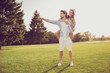 © deagreez - Leisure, chill happiness, lawn stroll, relax, romance lifestyle, well dressed partners. Full length of cute romantic bearded brunet guy in checkered shirt stands, dreamy lady rides him on rear
