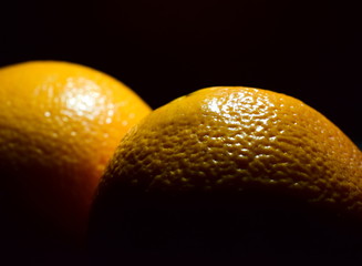 Two oranges on a black background