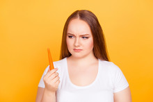 Young Woman Glaring At A Carrot
