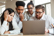 © Drobot Dean - Nervous young business colleagues using laptop computer.
