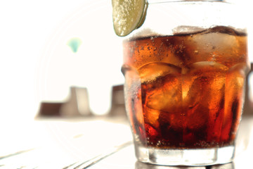 Cola in Glass on the Beach Table, with Blurred Background